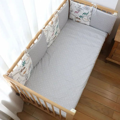 tour de lit pour bebe motif dinosaure gris et blanc installe autour du lit